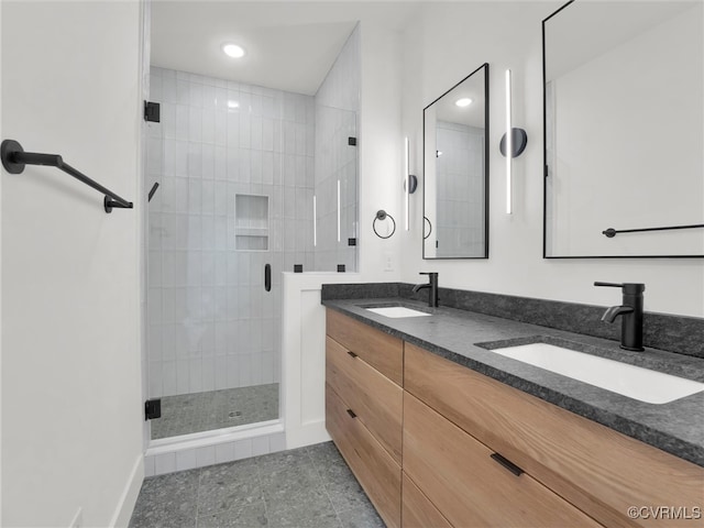 bathroom featuring vanity and a shower with shower door