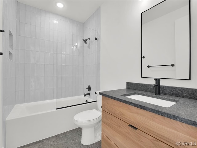 full bathroom featuring vanity, tiled shower / bath combo, toilet, and tile patterned flooring