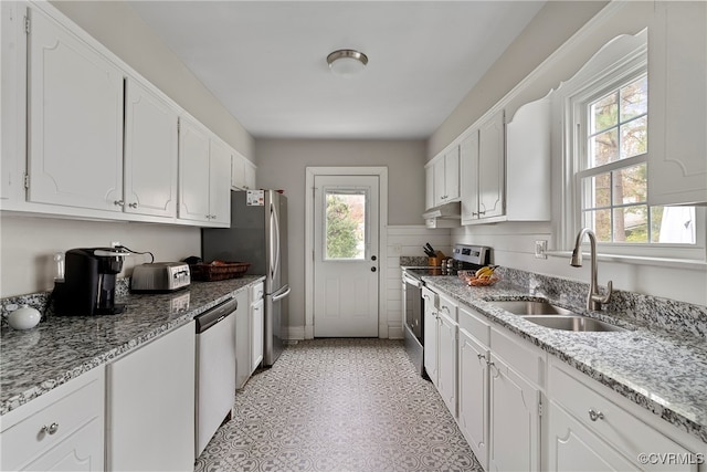 kitchen with white cabinets, plenty of natural light, and stainless steel appliances