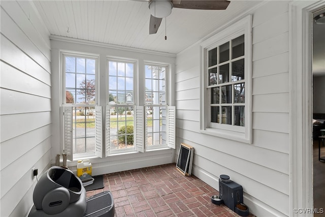 sunroom / solarium featuring ceiling fan and a healthy amount of sunlight