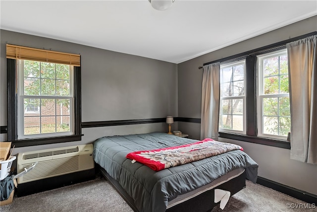 bedroom with carpet floors and a wall unit AC