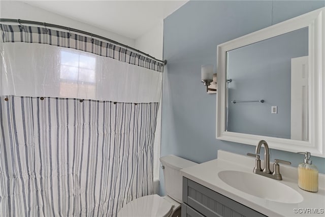 full bathroom featuring vanity, shower / bath combo, and toilet