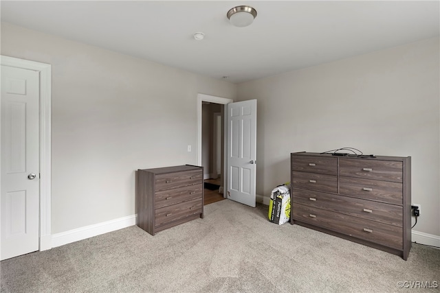 bedroom featuring light colored carpet