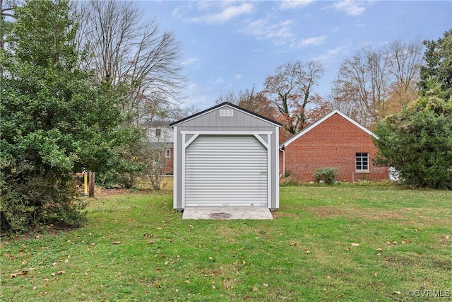 view of outbuilding with a garage and a yard