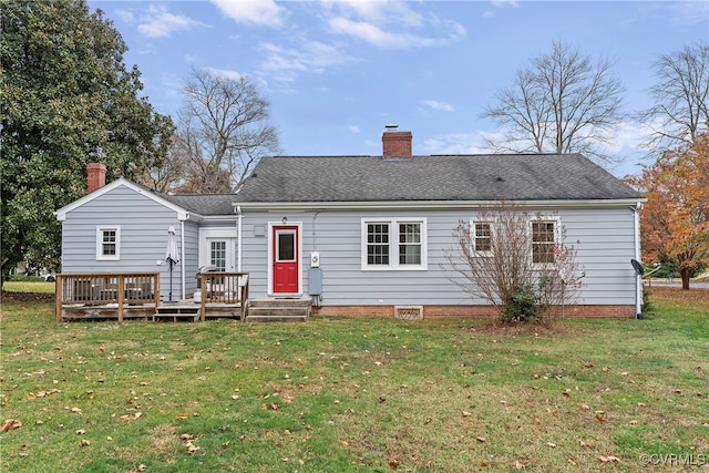 rear view of property with a lawn and a wooden deck