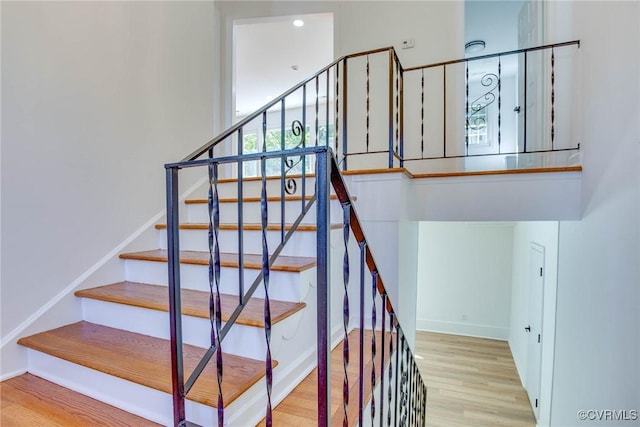 stairs featuring hardwood / wood-style flooring