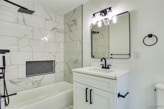 full bathroom featuring toilet, vanity, and tiled shower / bath combo