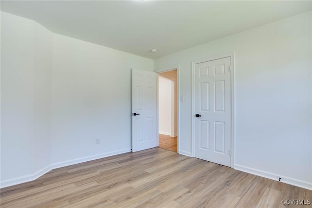 spare room featuring light wood-type flooring