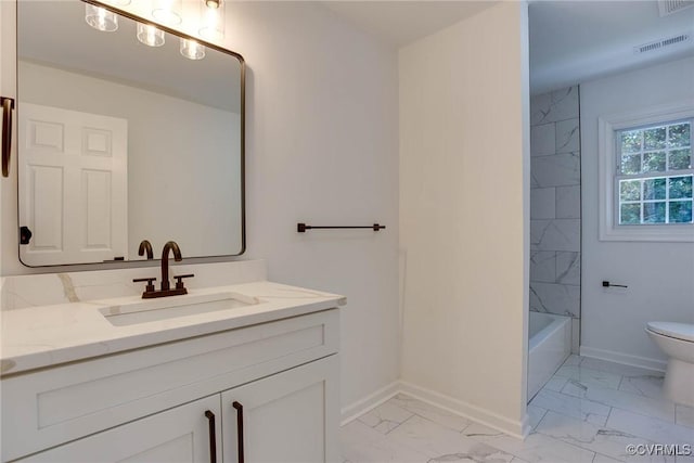 full bathroom with toilet, vanity, and tiled shower / bath combo