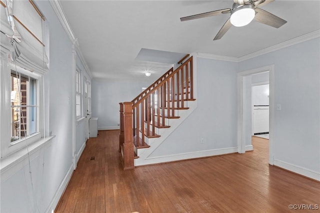 interior space featuring ornamental molding, hardwood / wood-style floors, and ceiling fan