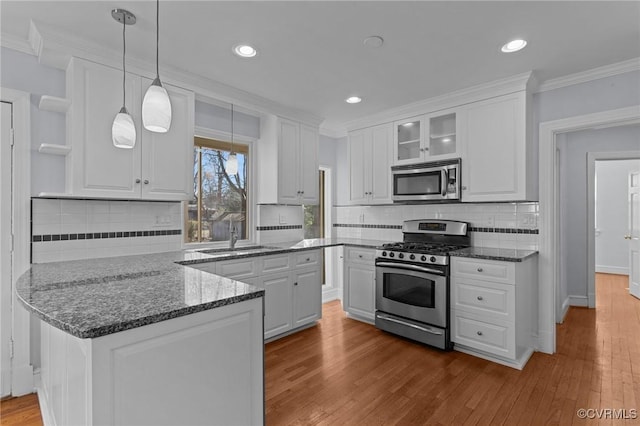 kitchen featuring sink, appliances with stainless steel finishes, and white cabinets