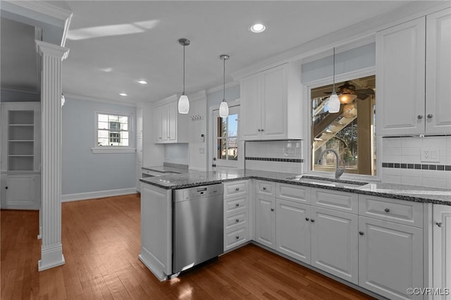 kitchen featuring dishwasher, ornamental molding, sink, white cabinetry, and ornate columns