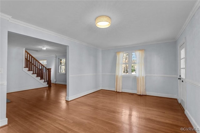 spare room featuring hardwood / wood-style flooring, plenty of natural light, and crown molding