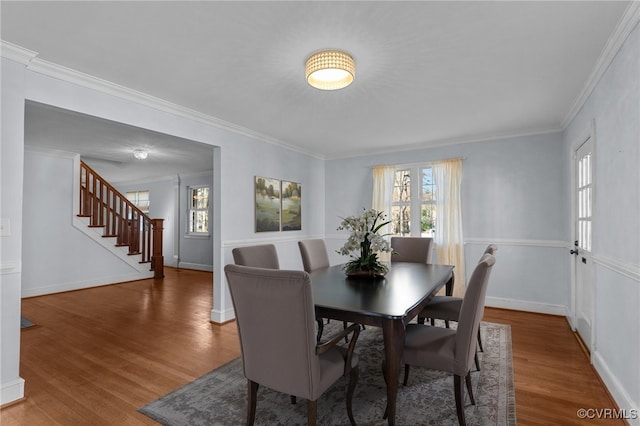 dining room featuring hardwood / wood-style flooring and crown molding