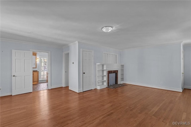 unfurnished living room with a fireplace, crown molding, and light wood-type flooring