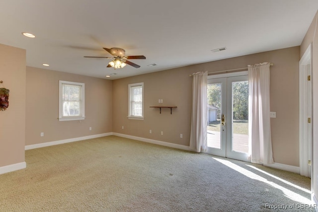 unfurnished room with french doors, ceiling fan, and light colored carpet