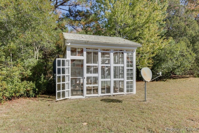 view of outbuilding featuring a yard