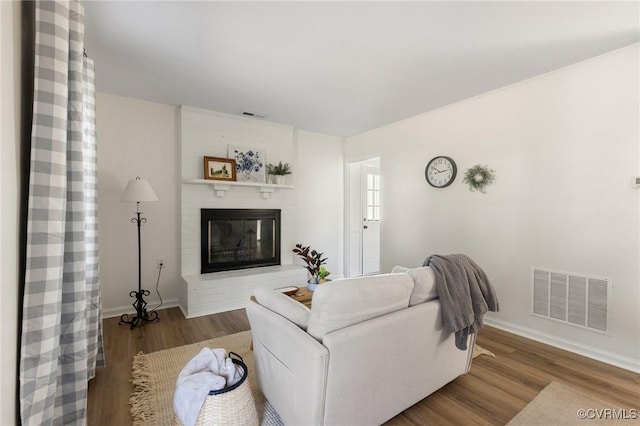 living room with hardwood / wood-style floors and a fireplace