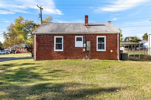 exterior space featuring cooling unit, a lawn, and a carport