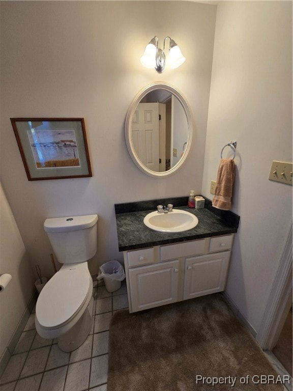 bathroom with vanity, toilet, and tile patterned floors