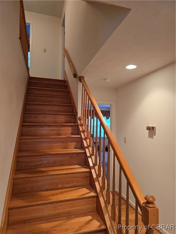 stairway featuring hardwood / wood-style floors