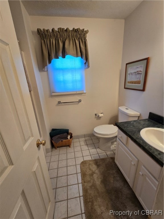 bathroom featuring vanity, toilet, and tile patterned floors