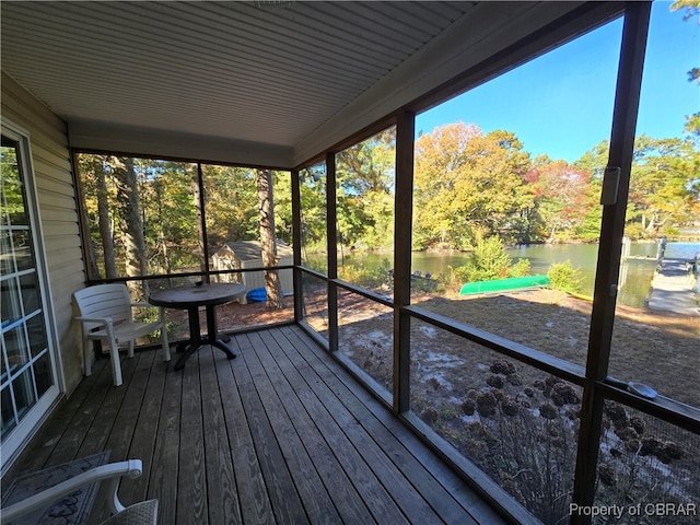 unfurnished sunroom with a water view