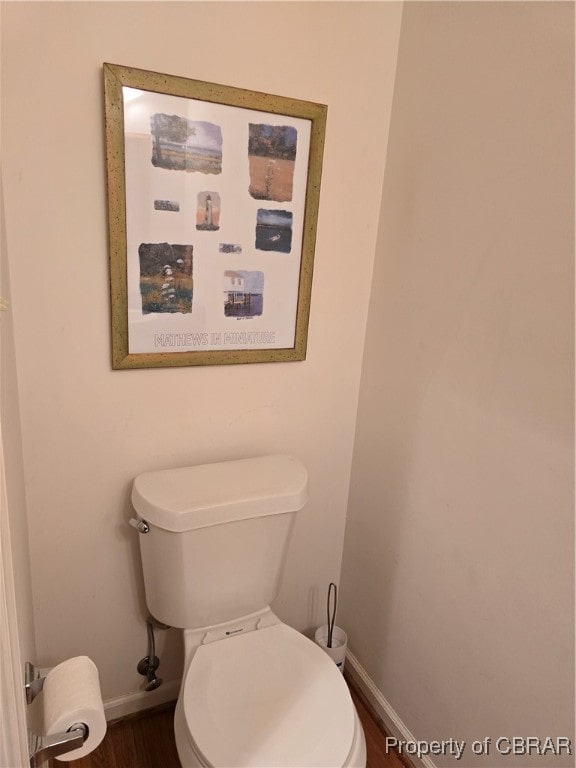 bathroom featuring hardwood / wood-style floors and toilet