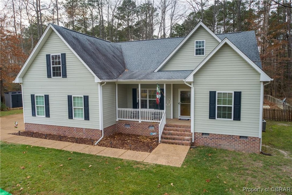 view of front of house featuring covered porch and a front yard