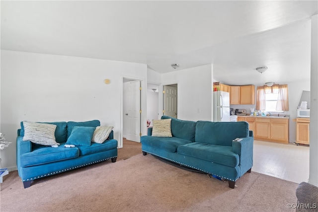 carpeted living room featuring sink