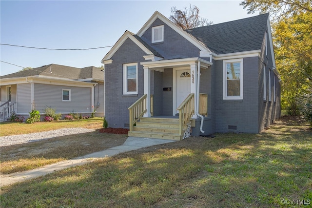 bungalow-style home featuring a front yard