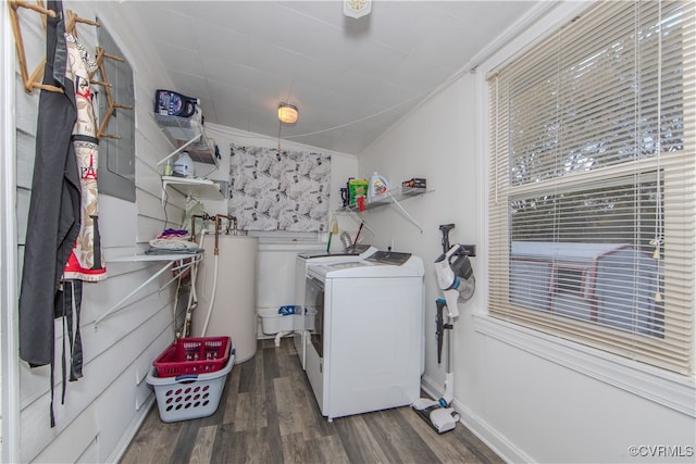 clothes washing area featuring dark hardwood / wood-style flooring, gas water heater, and washing machine and clothes dryer