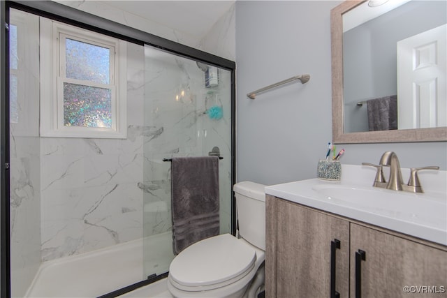 bathroom with vanity, walk in shower, and toilet