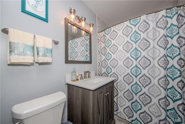 bathroom featuring walk in shower, vanity, and toilet