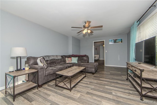 living room featuring hardwood / wood-style flooring and ceiling fan