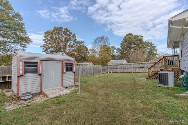 view of yard featuring a storage shed and central AC unit