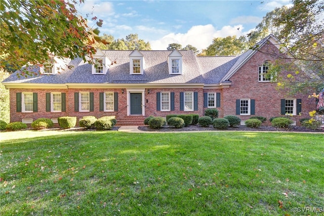 new england style home with a front yard