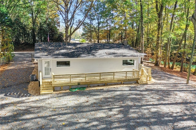 view of side of home featuring central air condition unit and a wooden deck