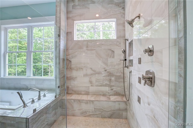 bathroom featuring shower with separate bathtub