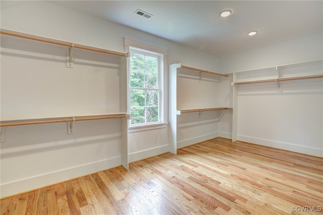 spacious closet with light hardwood / wood-style flooring