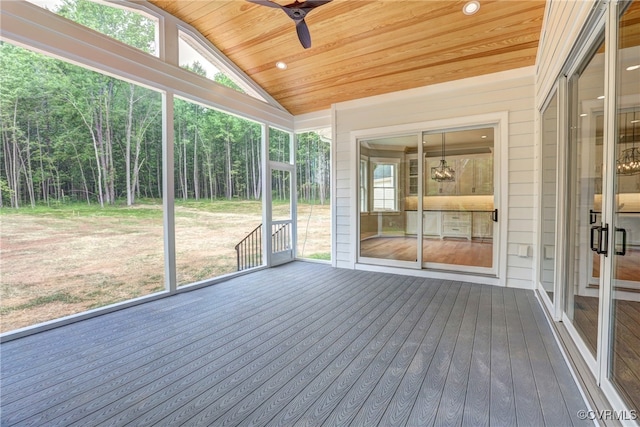 unfurnished sunroom featuring ceiling fan, wooden ceiling, and vaulted ceiling