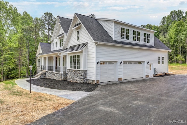 view of side of home with a porch and a garage