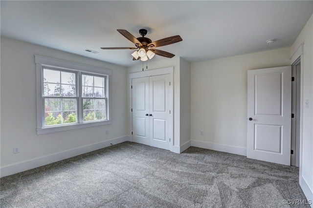 unfurnished bedroom featuring a closet, ceiling fan, and carpet