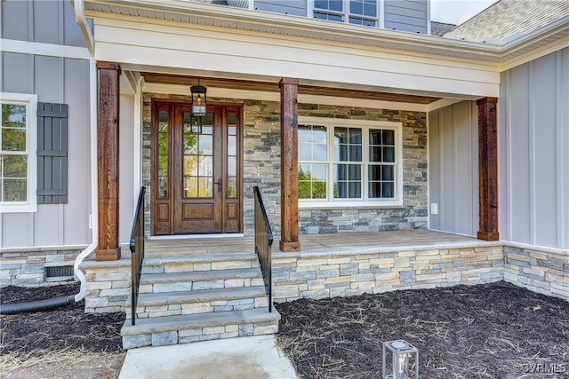 view of exterior entry with covered porch