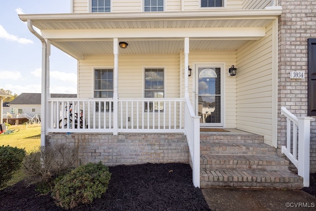 entrance to property featuring a porch