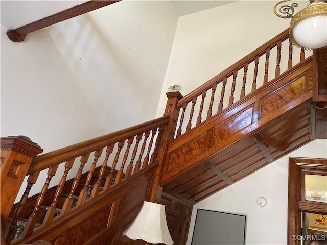 stairs with vaulted ceiling with beams