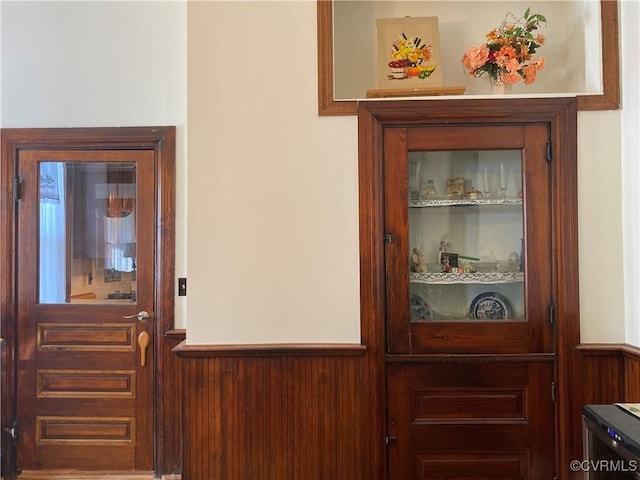 interior details with wooden walls, built in features, and wainscoting