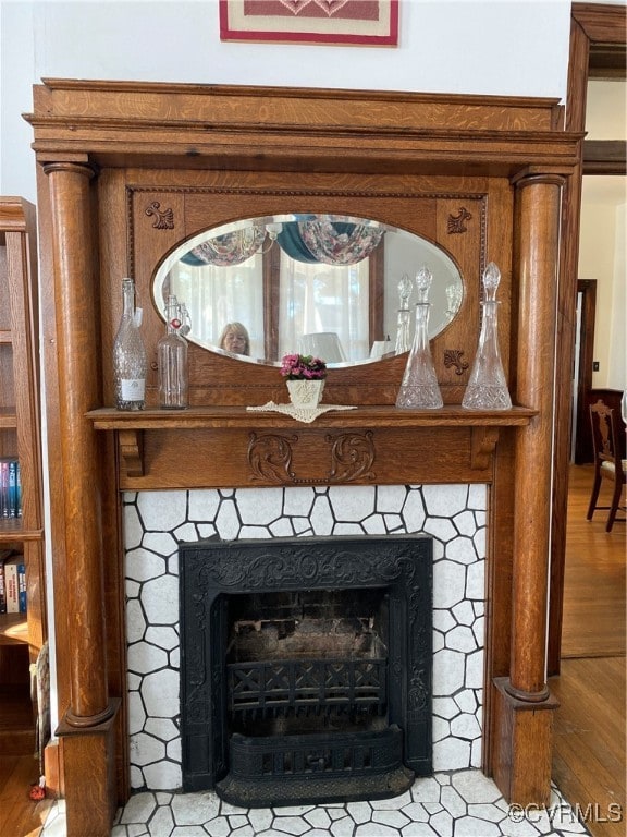 room details featuring hardwood / wood-style flooring and a tiled fireplace