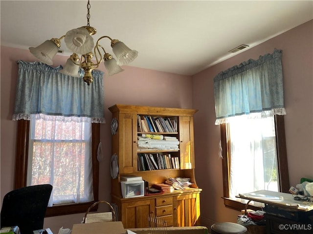 interior space with visible vents and an inviting chandelier