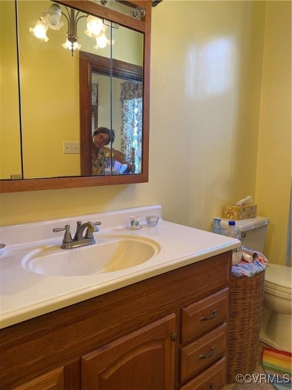 bathroom featuring toilet and vanity